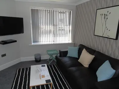 a living room with a couch and a table at Jeffersons Hotel & Serviced Apartments - The Steel Works in Barrow in Furness