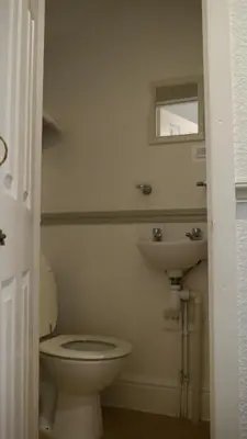 a bathroom with a toilet and a sink at Hornby House Hotel in Blackpool