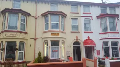 a large white building with a red at Hornby House Hotel in Blackpool