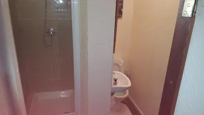 a bathroom with a shower and a toilet and a sink at Hornby House Hotel in Blackpool