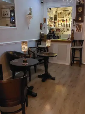 a room with tables and chairs and a bar at Westfield House in Blackpool