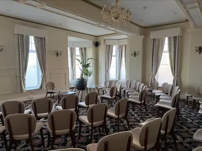 a room with rows of chairs and a chandelier at The Savoy Hotel in Blackpool