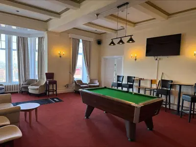 a living room with a pool table in it at The Savoy Hotel in Blackpool