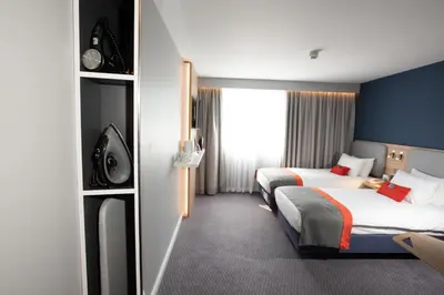 a hotel room with two beds and a window at Knowsley Inn & Lounge in Knowsley