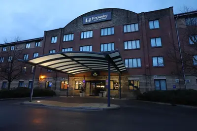 a large brick building with a sign in front of it at Knowsley Inn & Lounge in Knowsley