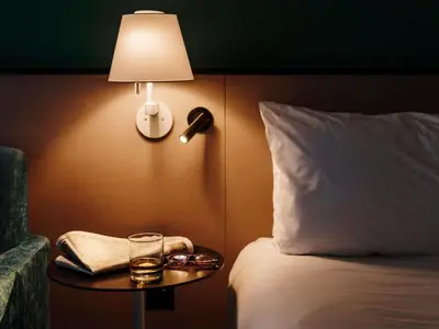 a hotel room with a bed and a table with a lamp at Mercure Haydock Hotel in Haydock