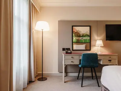 a hotel room with a desk and a bed at Mercure Haydock Hotel in Haydock