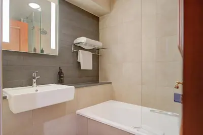 a bathroom with a white sink and a shower at Atlantic Tower Hotel Liverpool By Sunday in Liverpool