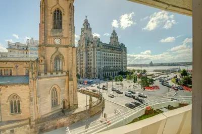 a church with a clock tower and a street at Atlantic Tower Hotel Liverpool By Sunday in Liverpool