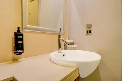 a white sink in a bathroom with a mirror at Atlantic Tower Hotel Liverpool By Sunday in Liverpool