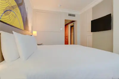 a white bed with white pillows in a bedroom at Atlantic Tower Hotel Liverpool By Sunday in Liverpool