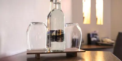 a bottle and two glasses sitting on a table at The Big Blue Hotel - Blackpool Pleasure Beach in Blackpool