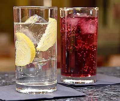 two glasses of water and a drink with lemon slices at Holiday Inn Express Liverpool-Albert Dock by IHG in Liverpool