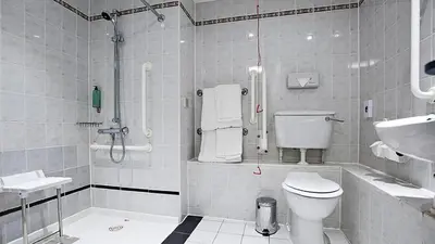 a bathroom with a shower and a toilet and a sink at Holiday Inn Express Liverpool-Albert Dock by IHG in Liverpool