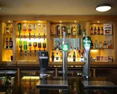 a bar with bottles of alcohol on the wall at The Dolby Hotel Liverpool - Free city centre parking in Liverpool