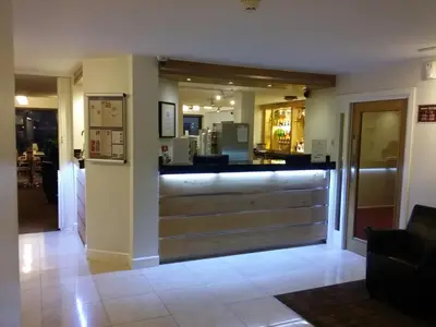 a restaurant with a bar in the middle of a lobby at The Dolby Hotel Liverpool - Free city centre parking in Liverpool