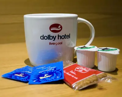 a cup of coffee and some food next to a cup of coffee at The Dolby Hotel Liverpool - Free city centre parking in Liverpool