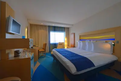 a hotel room with a large bed and a television at Radisson Blu Hotel, Liverpool in Liverpool