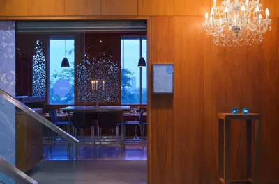 a dining room with a table and chairs and a chandelier at Radisson Blu Hotel, Liverpool in Liverpool