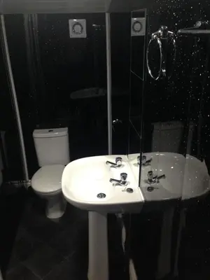 a bathroom with a white sink and a toilet at Yado Hotel in Blackpool