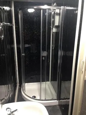 a shower in a bathroom with a toilet and a sink at Yado Hotel in Blackpool