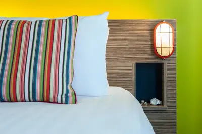 a bed with a pillow and a lamp and a window at Forshaws Hotel - Blackpool in Blackpool