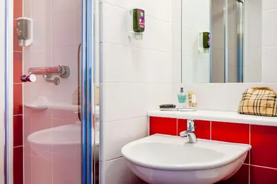 a bathroom with a sink and a toilet and a shower at Forshaws Hotel - Blackpool in Blackpool