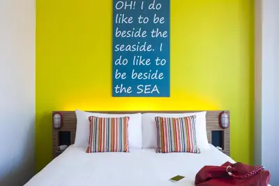 a bedroom with a bed with a sign above it at Forshaws Hotel - Blackpool in Blackpool