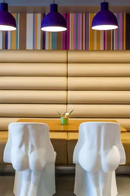 two white chairs sitting next to a table with lights at Forshaws Hotel - Blackpool in Blackpool
