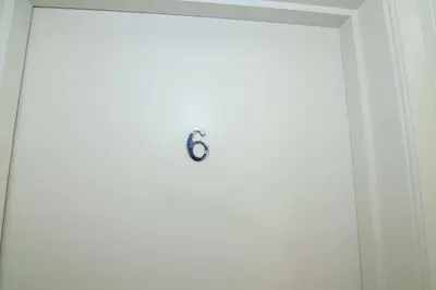 a door with a clock on it in a room at The Jollys in Bootle