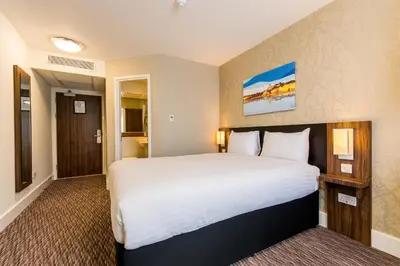 a hotel room with a large bed in it at Willows, Blackburn by Marston's Inn in Blackburn