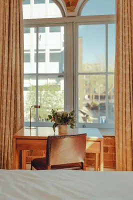 a desk with a plant on it in front of a window at Hope Street Hotel in Liverpool