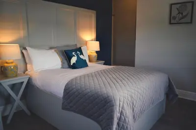 a bedroom with a large bed with two lamps at Shard Riverside in Poulton le Fylde