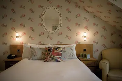 a bedroom with a bed with a mirror on the wall at Shard Riverside in Poulton le Fylde