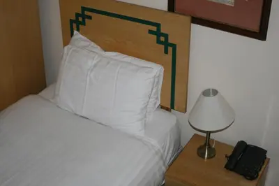 a bedroom with a bed and a lamp and a phone at Hanover Hotel & McCartney's Bar in Liverpool