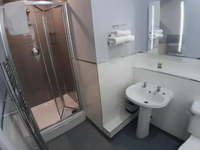 a bathroom with a shower and a sink at Hanover Hotel & McCartney's Bar in Liverpool