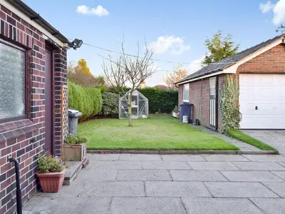 a brick house with a yard with a garage at Marstan House in Standish