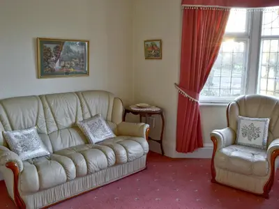 a living room with a couch and two chairs at Marstan House in Standish
