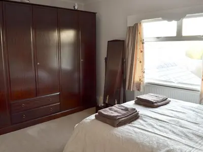 a bedroom with a bed with two towels on it at Marstan House in Standish