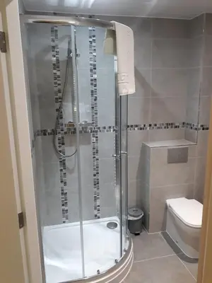 a bathroom with a shower and a toilet at The Avenue Hotel Ltd in Clitheroe