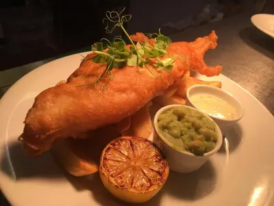 a plate of food with fish and chips and dip at The Avenue Hotel Ltd in Clitheroe