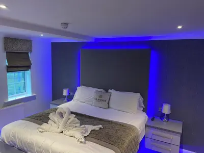 a bedroom with a bed with a towel on it at The Avenue Hotel Ltd in Clitheroe