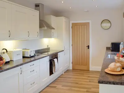 a kitchen with white cabinets and a counter top at Holgate's Granary in Pendleton