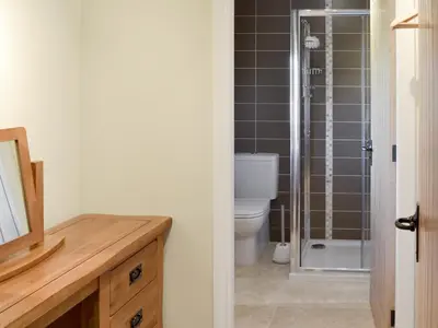 a bathroom with a toilet and a glass shower at Holgate's Granary in Pendleton