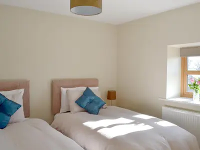 a bedroom with two beds with blue pillows at Holgate's Granary in Pendleton