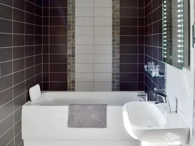 a bathroom with a white tub and a sink at Holgate's Granary in Pendleton
