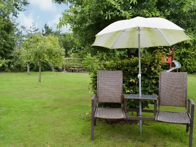 a table and two chairs with an umbrella at The Dairy in Burscough