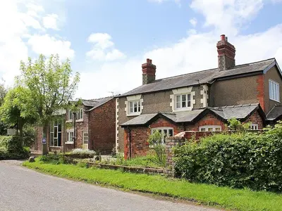 an old brick house on the side of a road at The Granary in Burscough