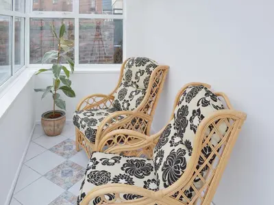 two wicker chairs in a room with a plant at Sandfield The Promenade in Southport