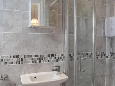 a bathroom with a sink and a shower at Sandfield The Promenade in Southport